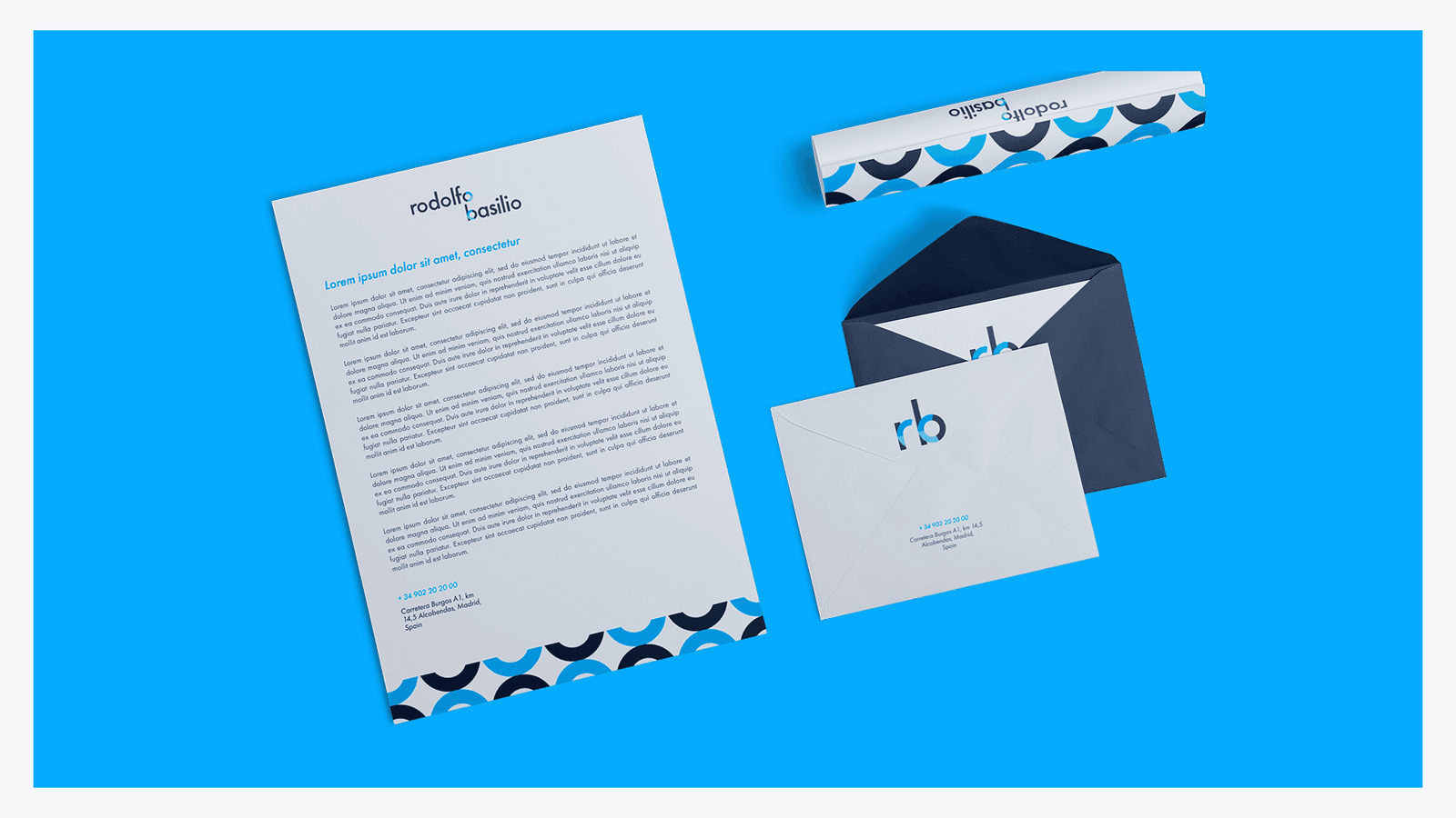 Stationery mockup on cyan: a branded letterhead beside a navy envelope with a patterned lining