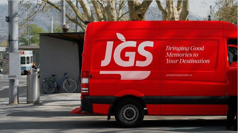 A red JGS van reading Bringing Good Memories to Your Destination