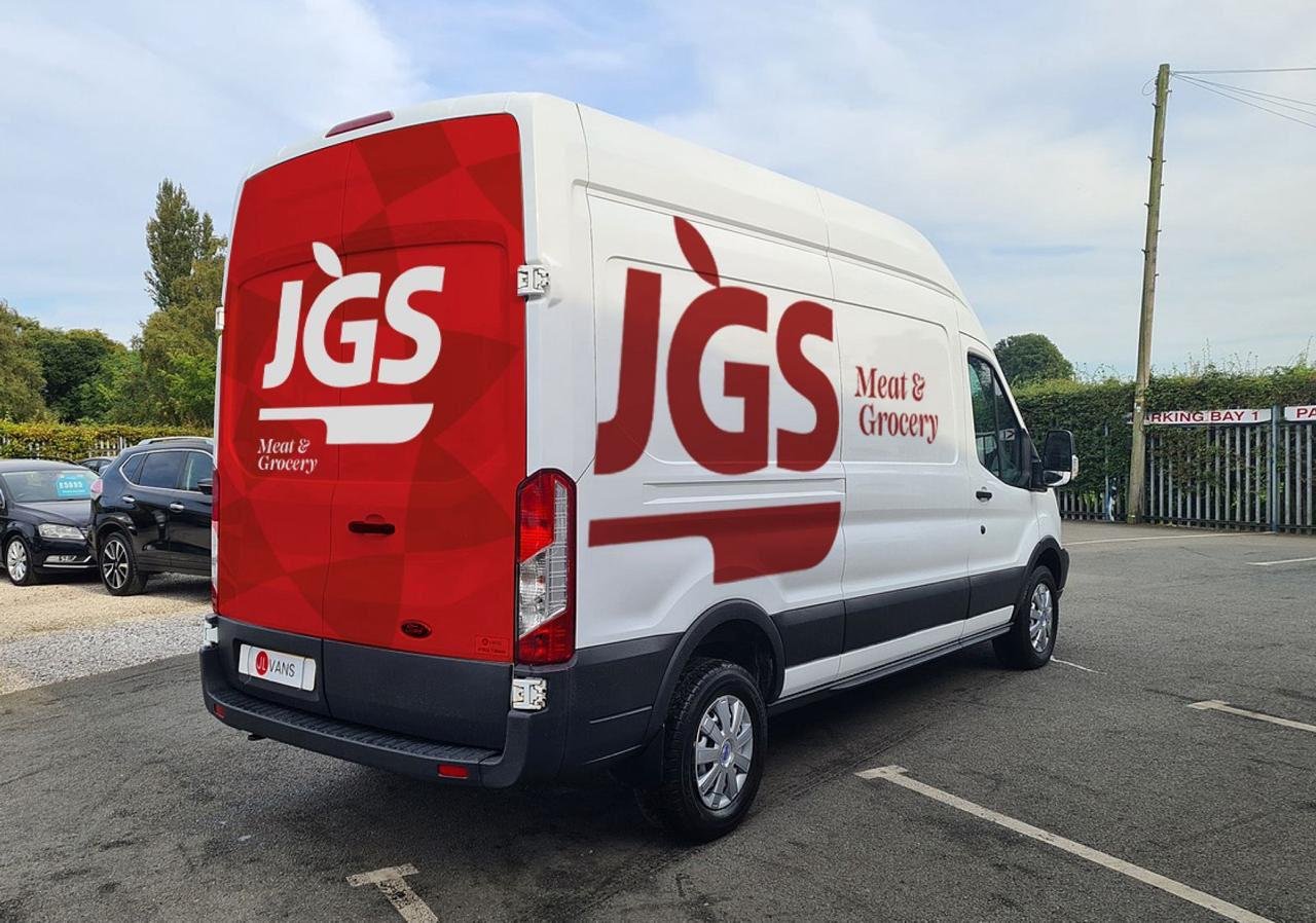 A white JGS delivery van seen from the rear, carrying the logo across its doors