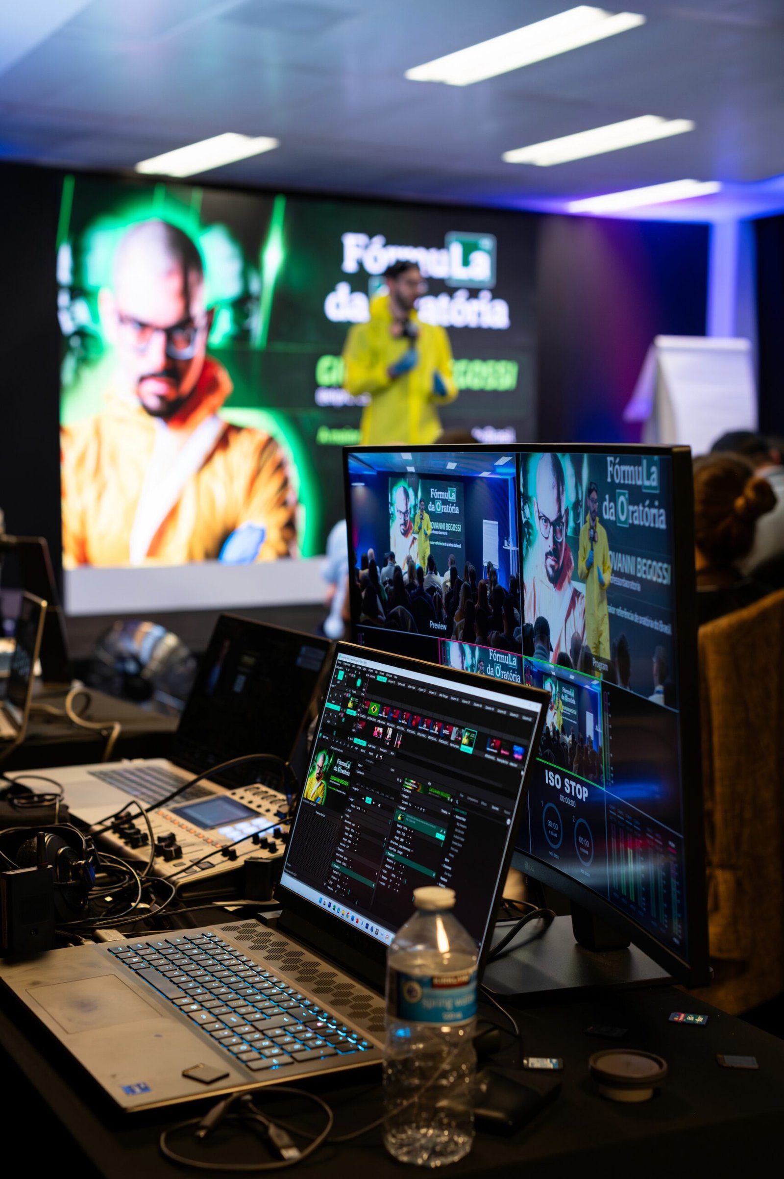 The production desk at the event, laptops and monitors carrying the live stage feed