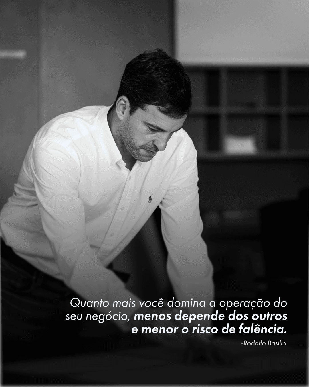 A black and white photograph of Rodolfo Basilio leaning over a work surface, captioned with a quote about mastering your own operation